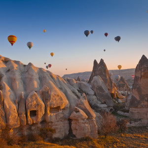 Hot Air Balloons rise up over the Goreme Valley in Cappadocia, Turkey